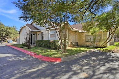 View of front of property featuring stone siding, a shingled roof, and a front lawn