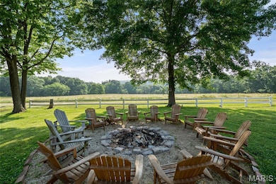 View of patio featuring a fire pit and a view of rural / pastoral area