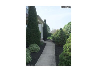 The manicured walk leads to the front entrance of 