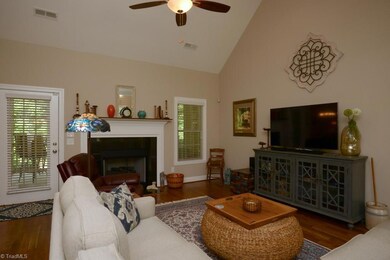 Spacious family room with expanded mantle opens onto screened porch