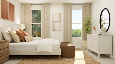 Bedroom featuring multiple windows and light colored carpet