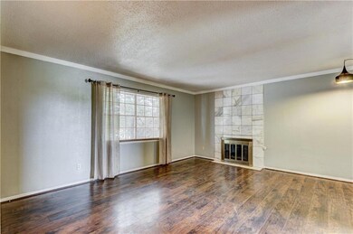Unfurnished living room featuring a textured ceili