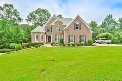 Georgian-style home with brick siding and a front lawn