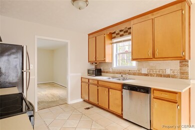 Kitchen with tasteful backsplash, appliances with