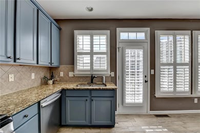 Kitchen featuring stainless steel appliances and access to deck
