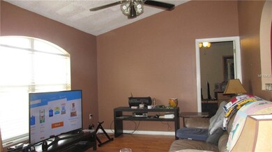 Formal Living Room with Owner's Suite tucked off the to the Right (Ceiling fan belongs to the tenant)