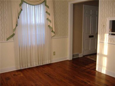 Dining Room. HW flooring exposed, wall paper below