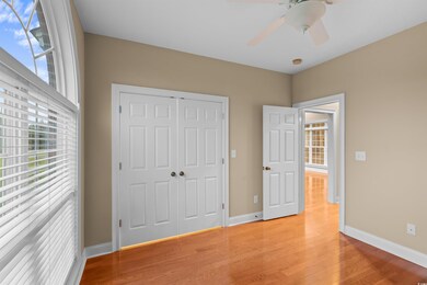 Unfurnished bedroom featuring a closet, light hard