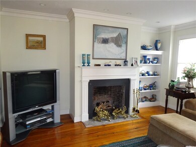 Living Room with Fireplace, Wood Floors and Built-