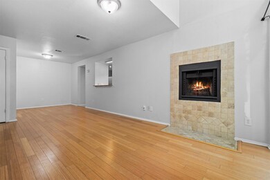 Unfurnished living room with a tiled fireplace an
