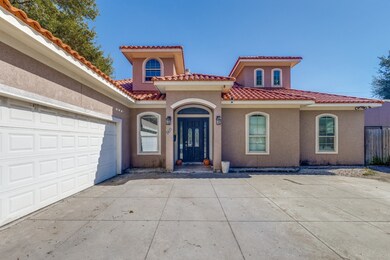 Mediterranean / spanish-style home with a garage, stucco siding, concrete driveway, and a tile roof