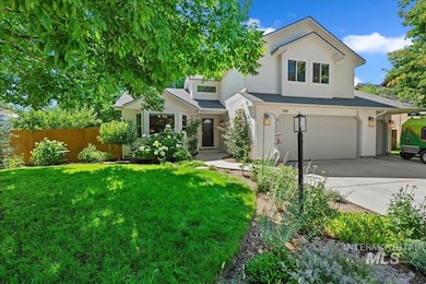 View of front of home featuring an attached garage, driveway, and brick siding