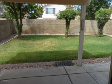 GRASS BACK YARD WITH COVERED PATIO