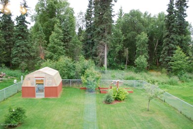 Backyard has greenhouse