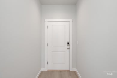 Doorway to outside featuring baseboards and wood finished floors