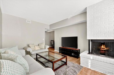 Living room with wood finished floors and a fireplace