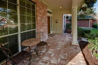 Gorgeous front porch with watering system for hanging plants