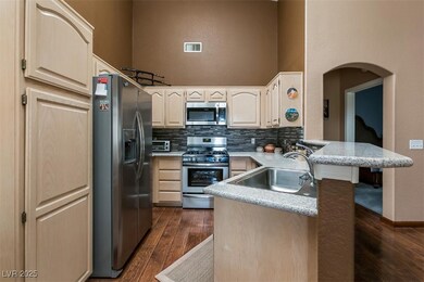 Kitchen with stainless steel appliances, a peninsu