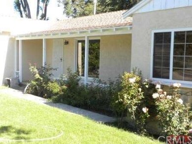 Mature shrubs and trees throughout the property.
