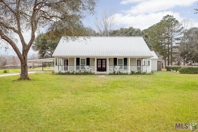 Porch surrounding the front with driveway and carp