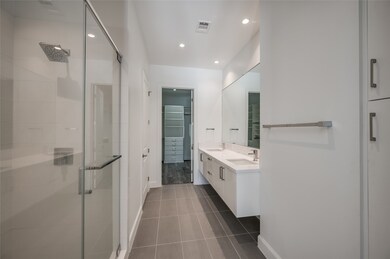 The expansive primary bathroom offers a luxurious