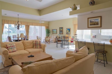 Living room with ceiling fan with notable chandeli