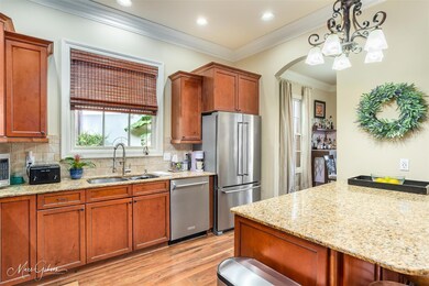 Kitchen featuring tasteful backsplash, sink, light
