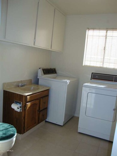 Inside laundry room with half bath