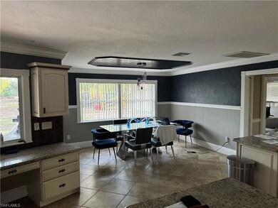 Tiled dining area featuring a wainscoted wall, ple