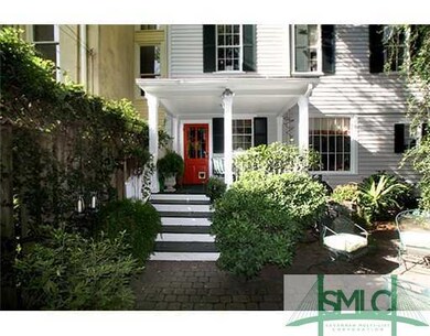 Exterior Back. The rear brick courtyard features a
