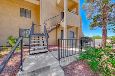 Entrance to property with stucco siding and a balc