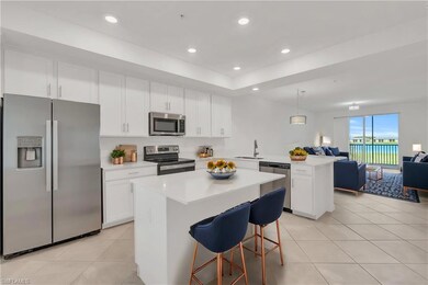 Kitchen with a center island, white cabinetry, a k
