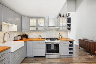 Kitchen with stainless steel appliances, a sink, w