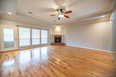 Living room with fresh paint, tray ceiling wood fl