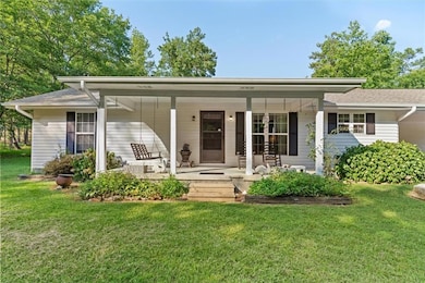 Single story home featuring a front yard and a porch