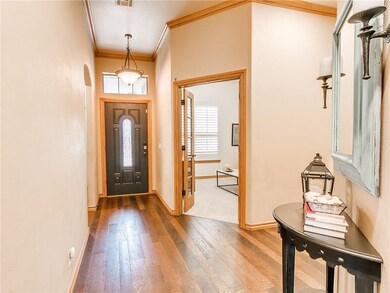 Front entry with hardwood floors and crown mouldin