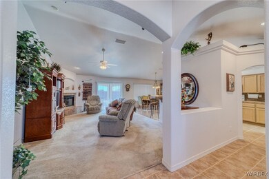 Living room featuring ceiling fan, light colored c