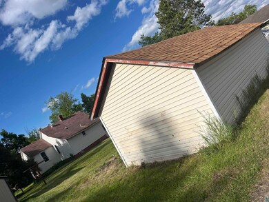 View of home's exterior with a yard