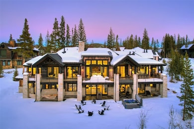 Snow covered rear of property with a balcony
