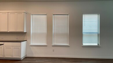 Unfurnished dining area featuring dark wood-type flooring