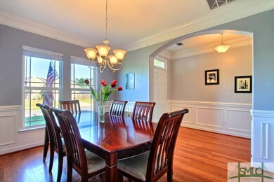 Wood floors, trim and crown molding extends throug