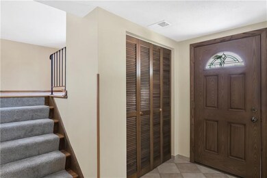 Spacious foyer with updated flooring & custom fron