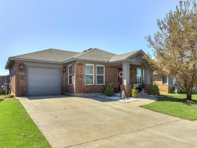 View of front of home with roof with shingles, brick siding, driveway, and a front lawn
