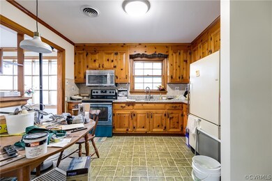 Additional view of eat-in kitchen. Room has linoleum floor, overhead lights, and a full height pantry cabinet next to the refrigerator.