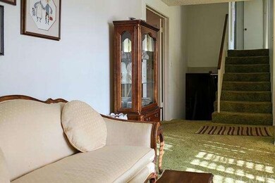 Staircase off the living room and kitchen.