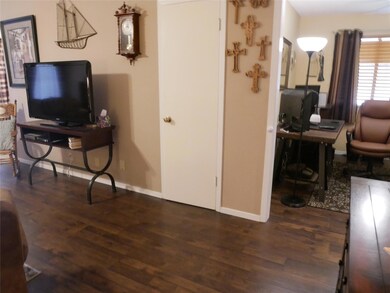 Living room with wood finished floors and an offi