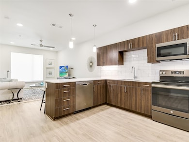 Kitchen featuring a sink, open floor plan, light 