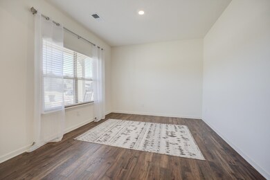 Spare room featuring visible vents, baseboards, an