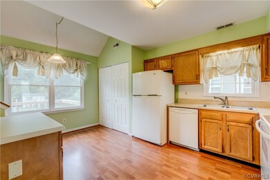 Kitchen - laminate floors, tile backsplash, pantry