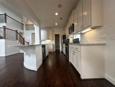 Kitchen featuring appliances with stainless steel finishes, dark wood-type flooring, backsplash, and recessed lighting